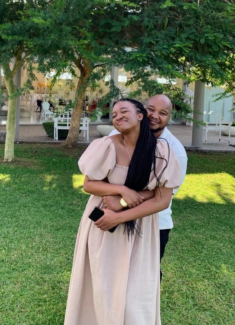 Naledi and Nkanyiso sharing a joyful embrace outdoors